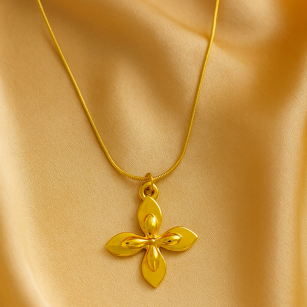 Gold necklace with a cross pendant on a beige fabric background