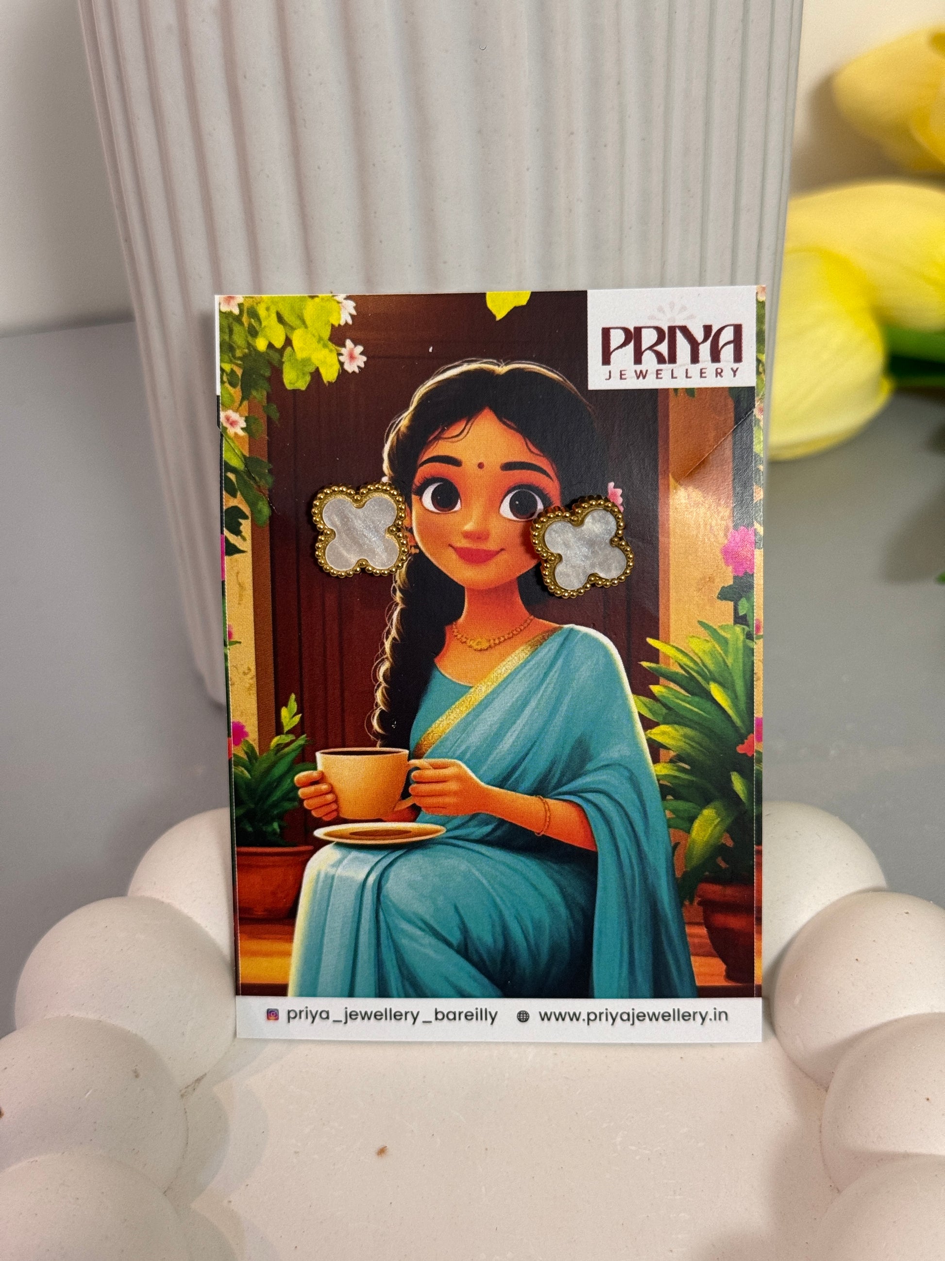 Card with a colorful illustration of a character holding a flower, placed on a white surface.