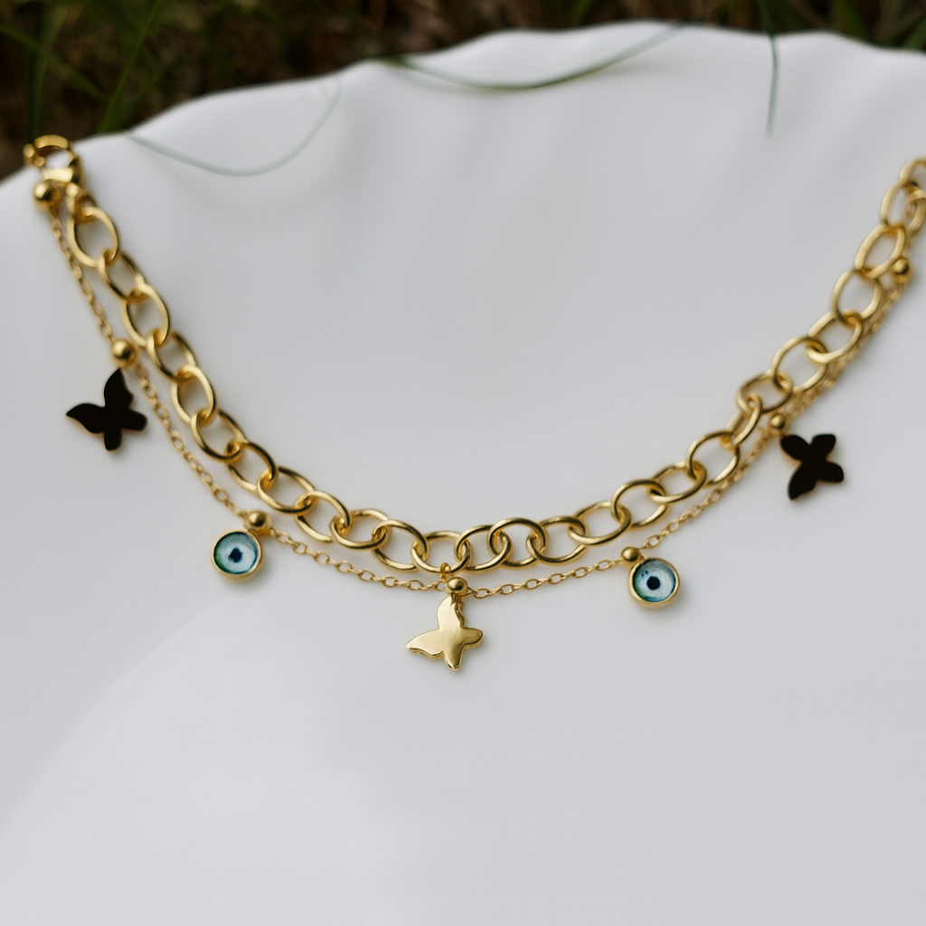 Gold chain necklace with charms on a white surface