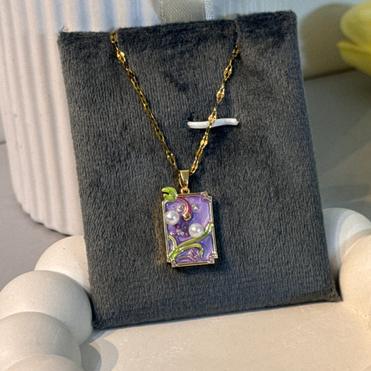 Jewelry box with a necklace on a gray stand against a white background