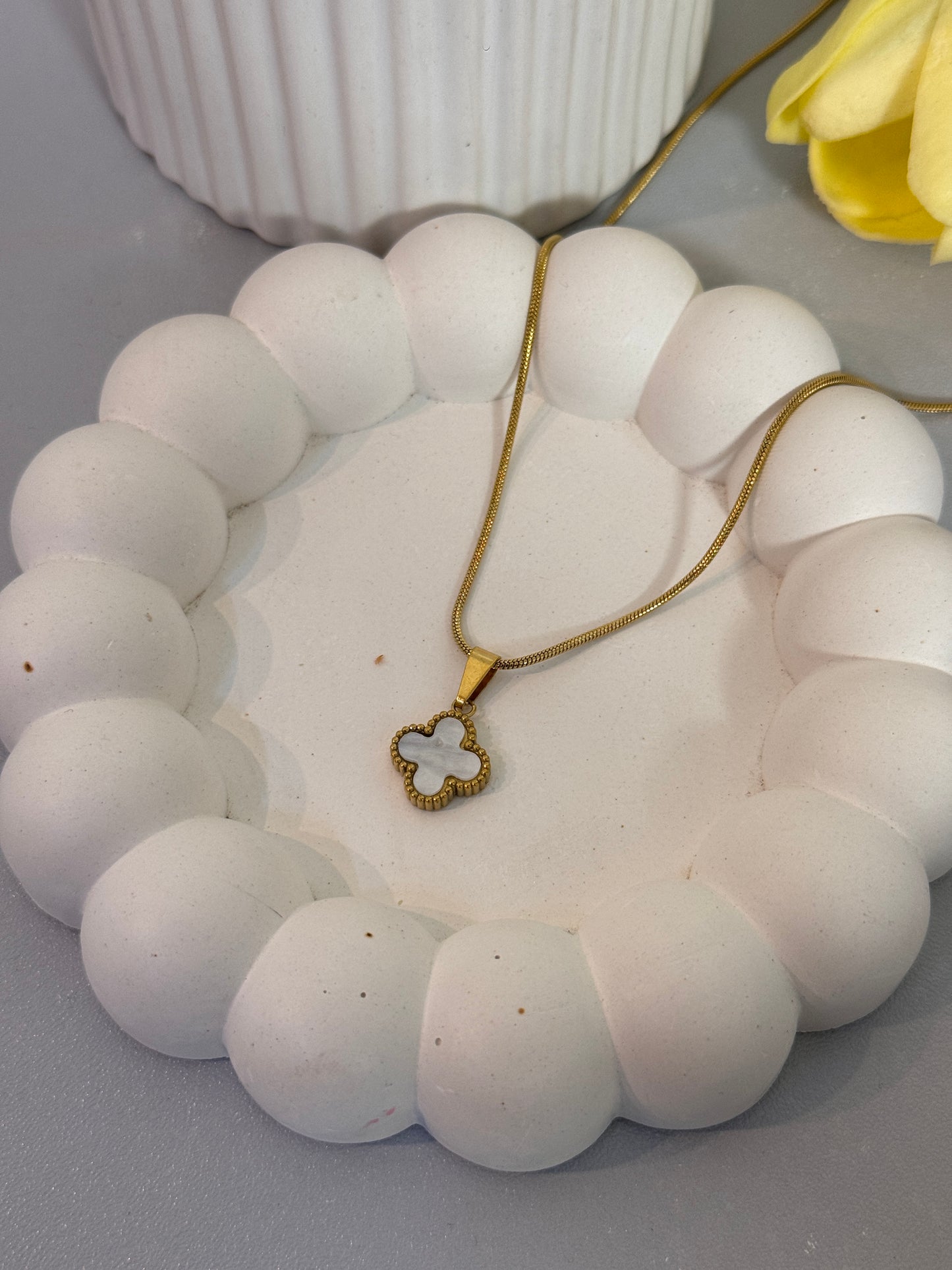 Necklace with a heart-shaped pendant on a white stone surface