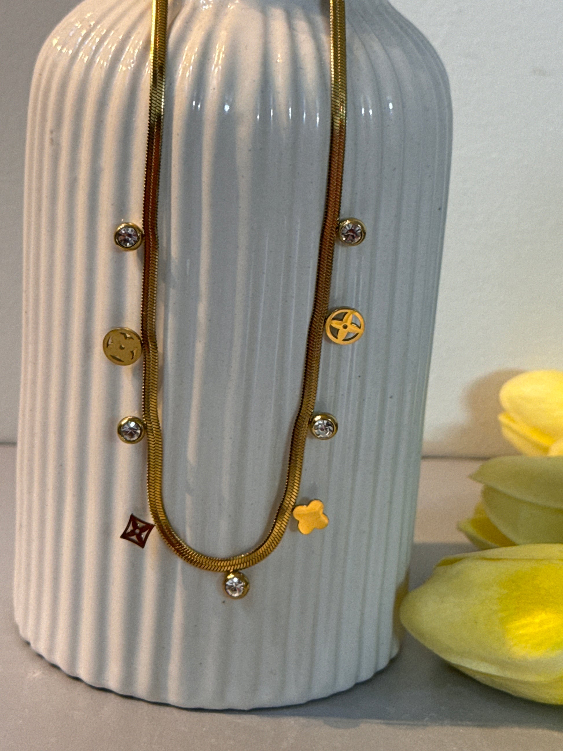 Gold hair clip with decorative elements on a textured white surface