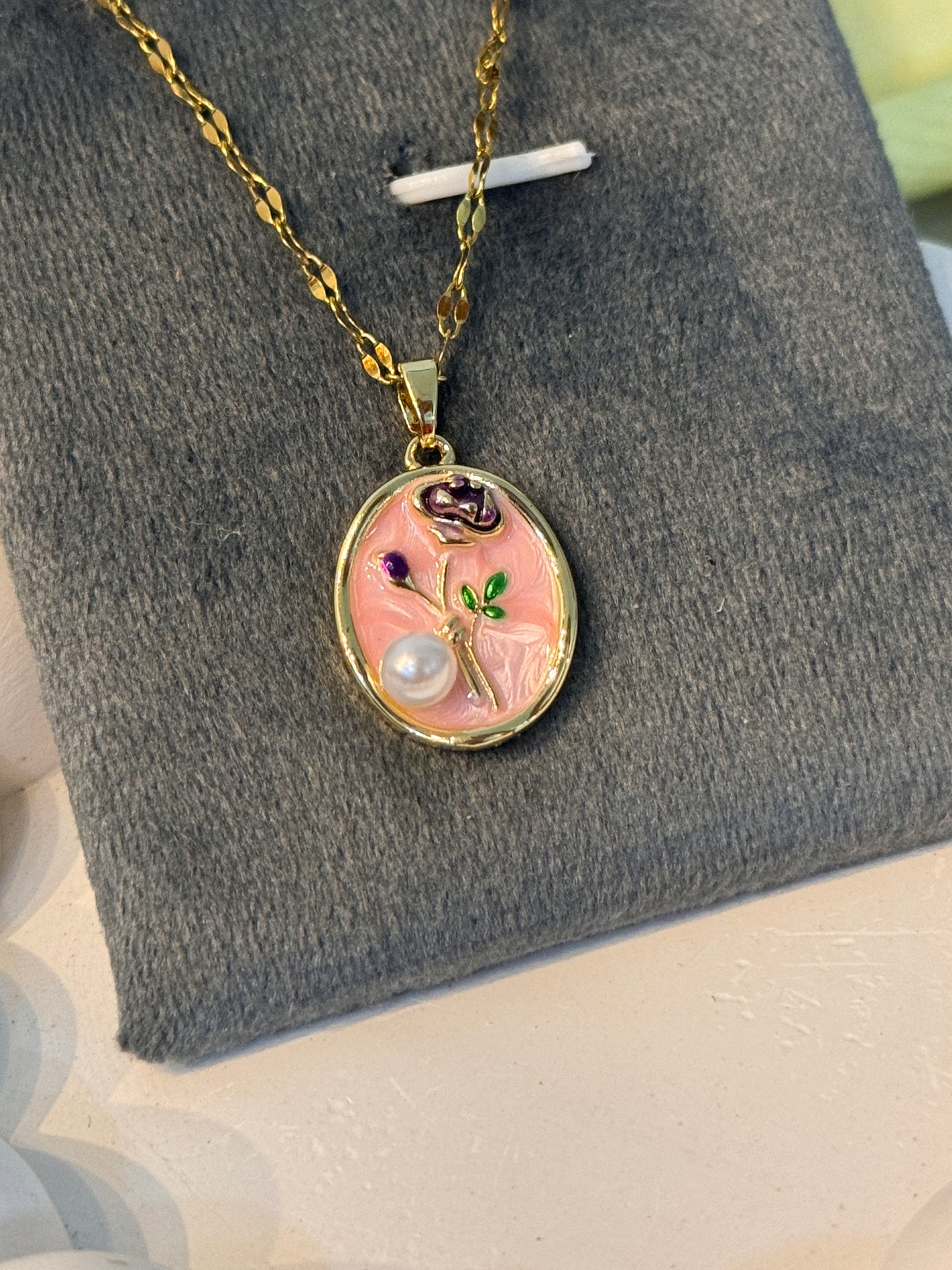 Necklace with a decorative pendant on a gray surface