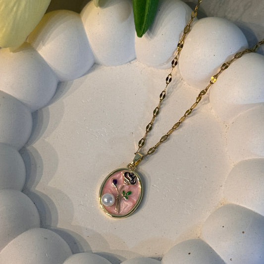 Necklace with a pink pendant on a white textured surface