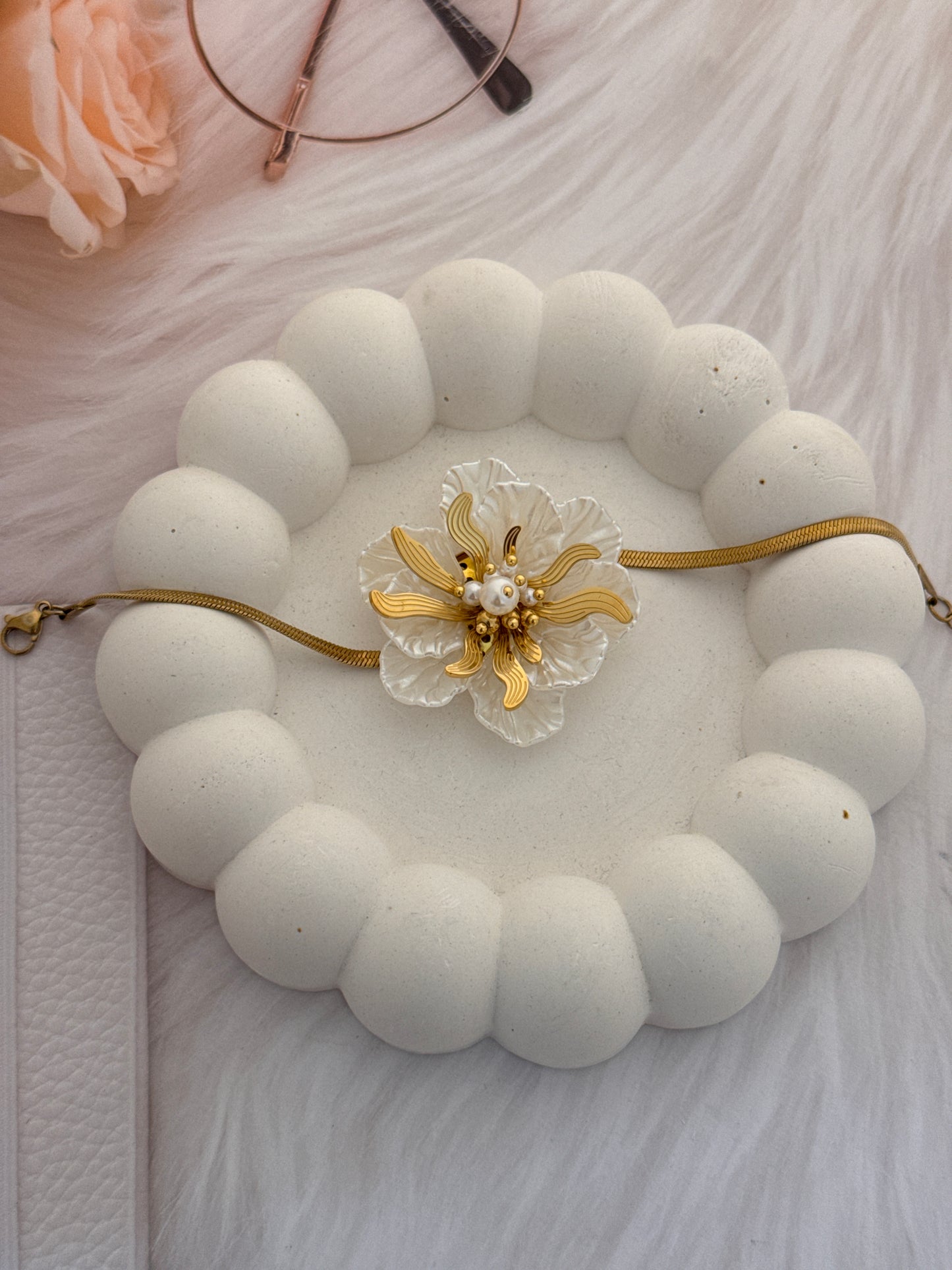 Decorative bracelet with floral design on a textured surface