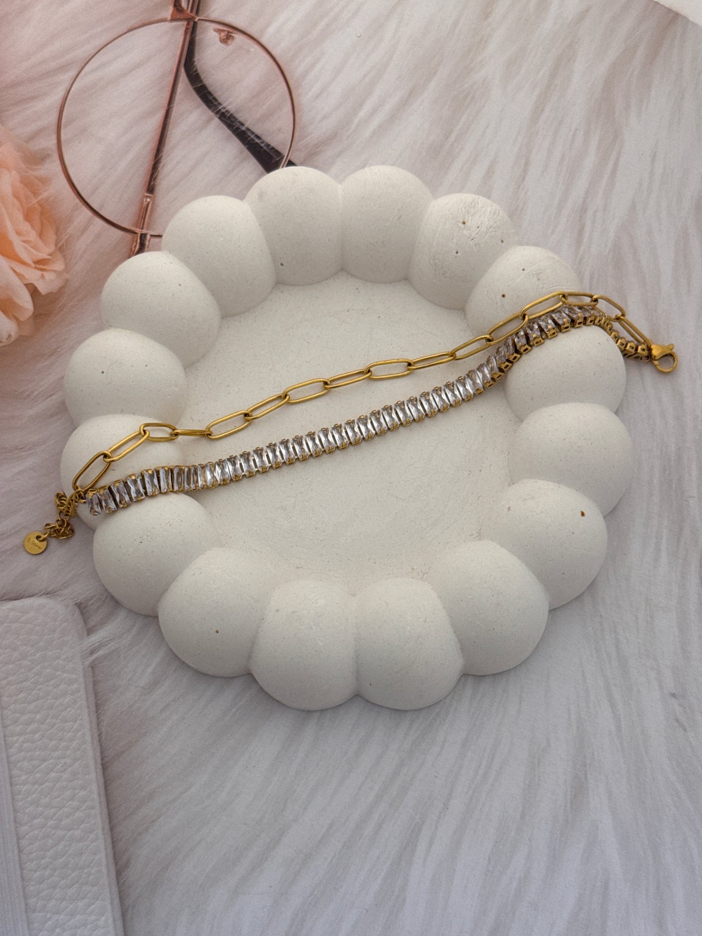 Necklace on a white cloud-shaped stand with a soft pink background