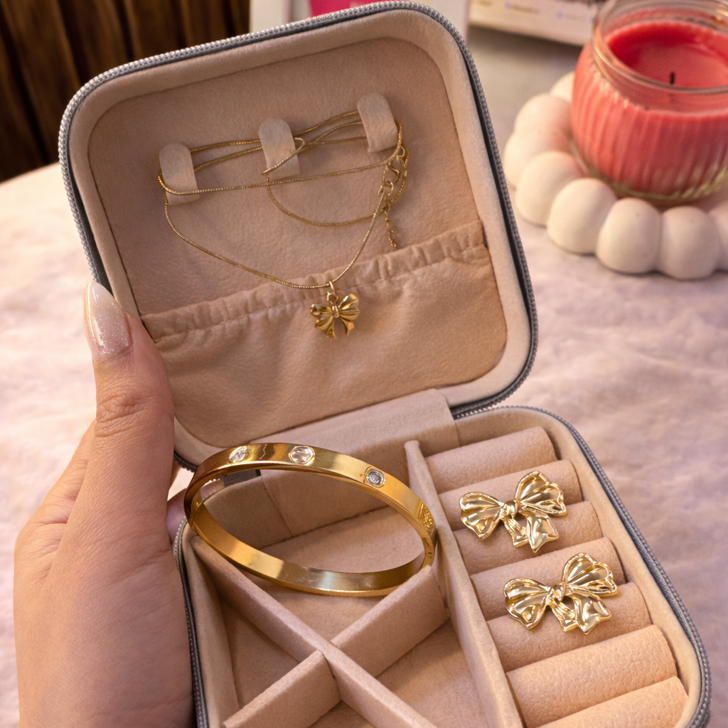Jewelry set including a bracelet, necklace, and earrings in an open jewelry box.