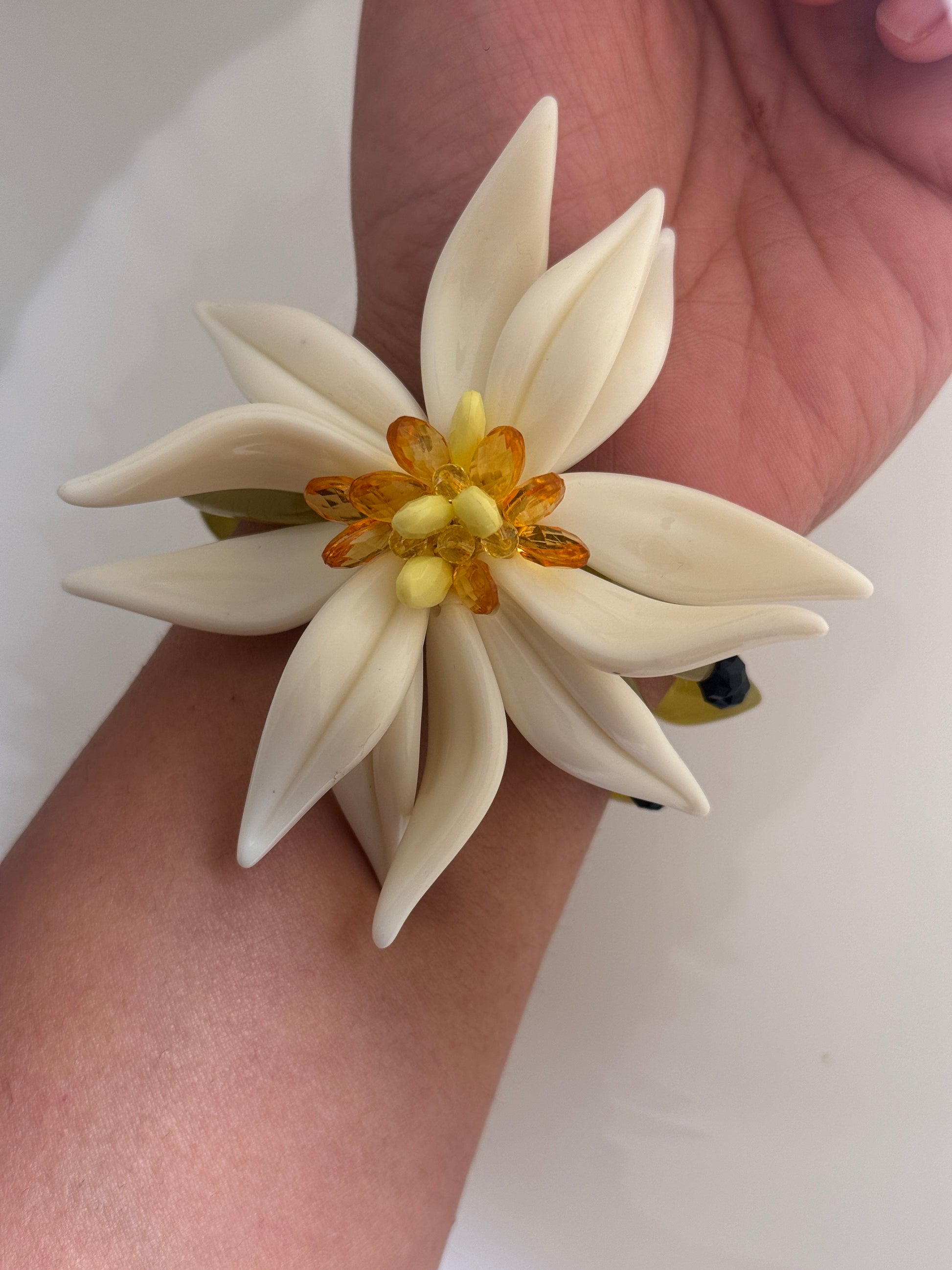 Floral bracelet on a wrist against a white background