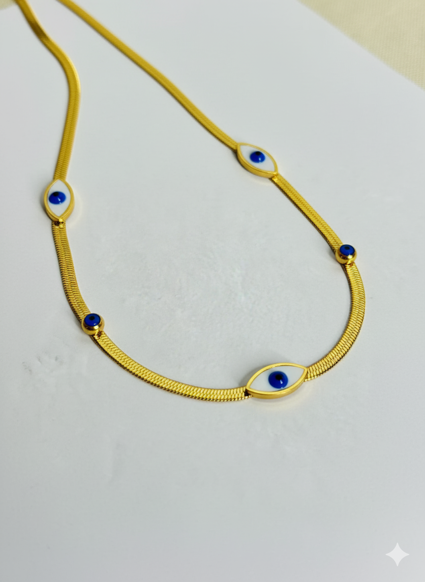 Gold necklace with blue stones on a white background