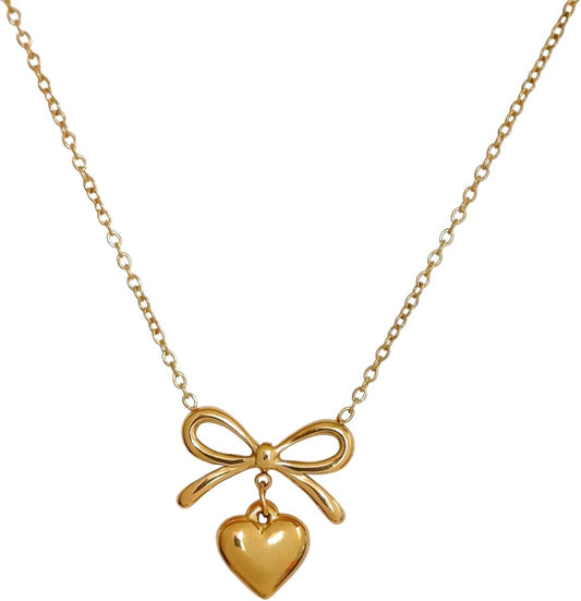 Gold necklace with a bow and heart pendant on a white background