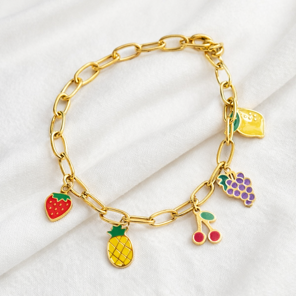 Gold bracelet with colorful fruit charms on a white background