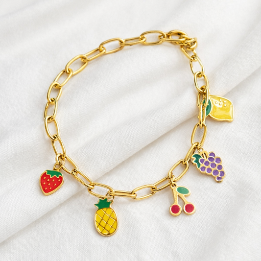 Gold bracelet with colorful fruit charms on a white background