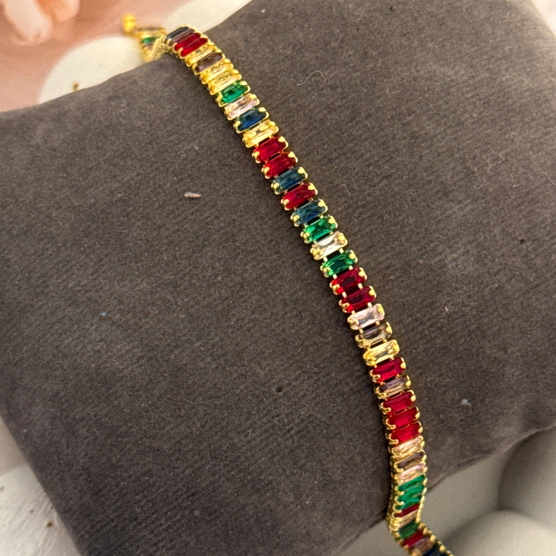 Multicolored gemstone bracelet on a gray surface