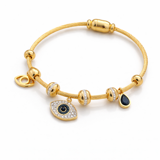 Gold bracelet with an evil eye charm on a white background