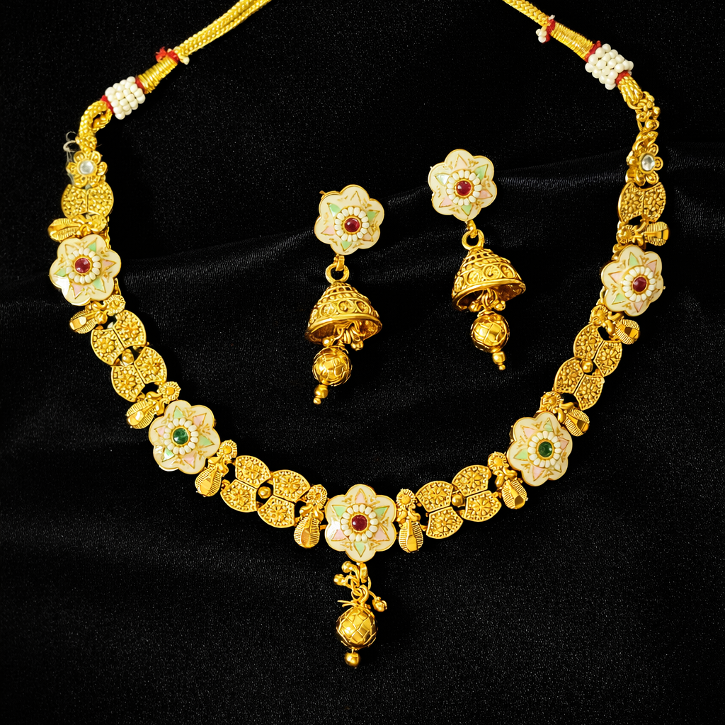 Gold necklace and earrings set on a black background