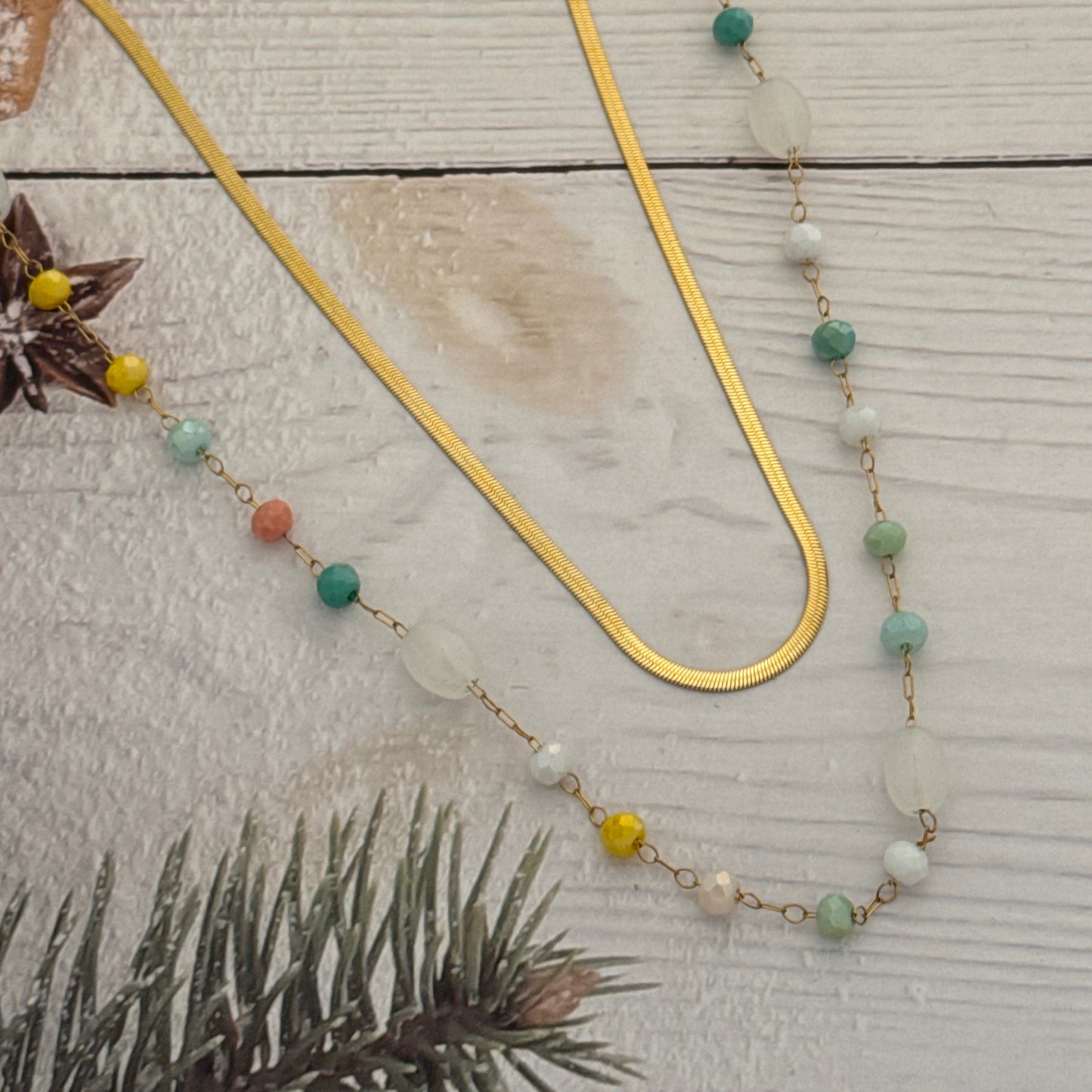 Decorative garland with beads and pine cones on a wooden surface