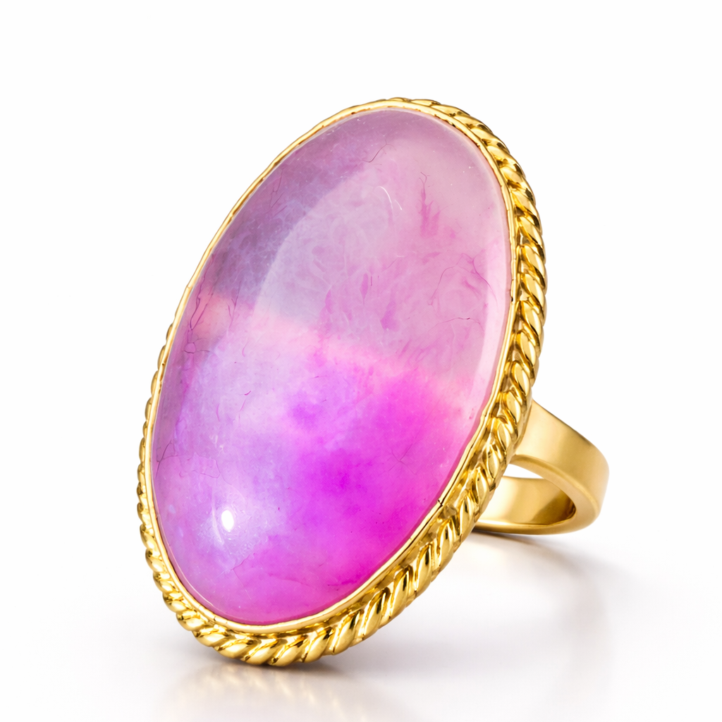Gold ring with a pink gemstone on a white background