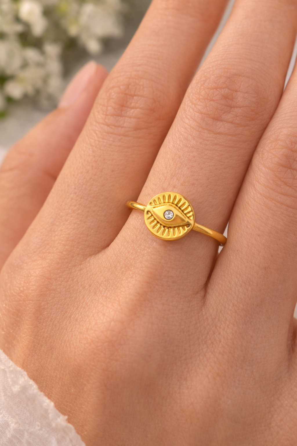 Gold ring with a diamond on a person's finger