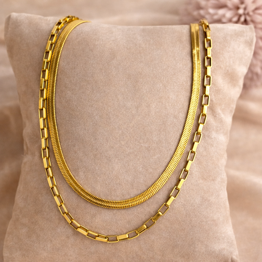 Gold necklace on a beige pillow with a soft background