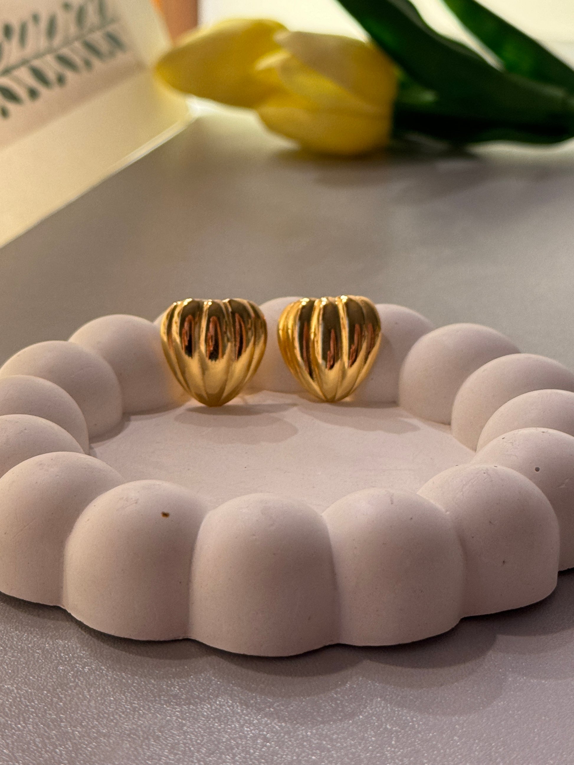 Goldearingson a textured white surface with a blurred background