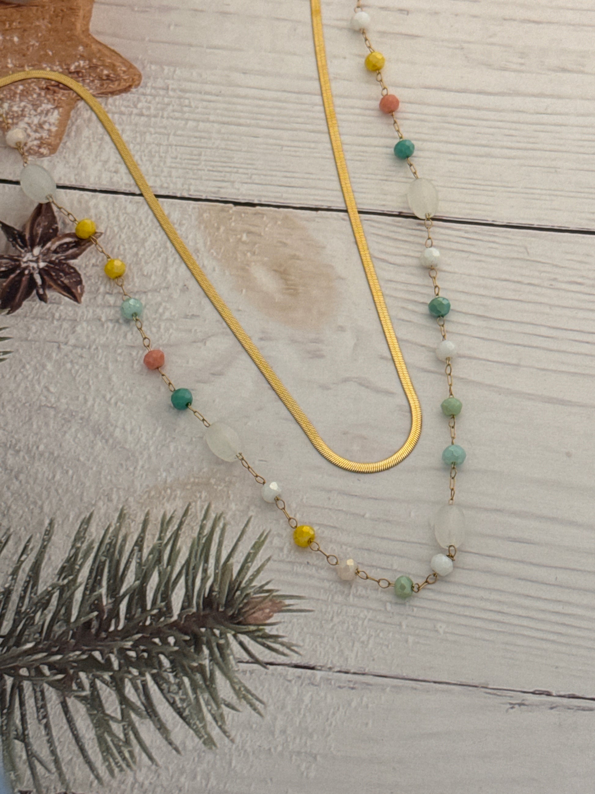 Necklace with colorful beads on a wooden surface with decorative elements