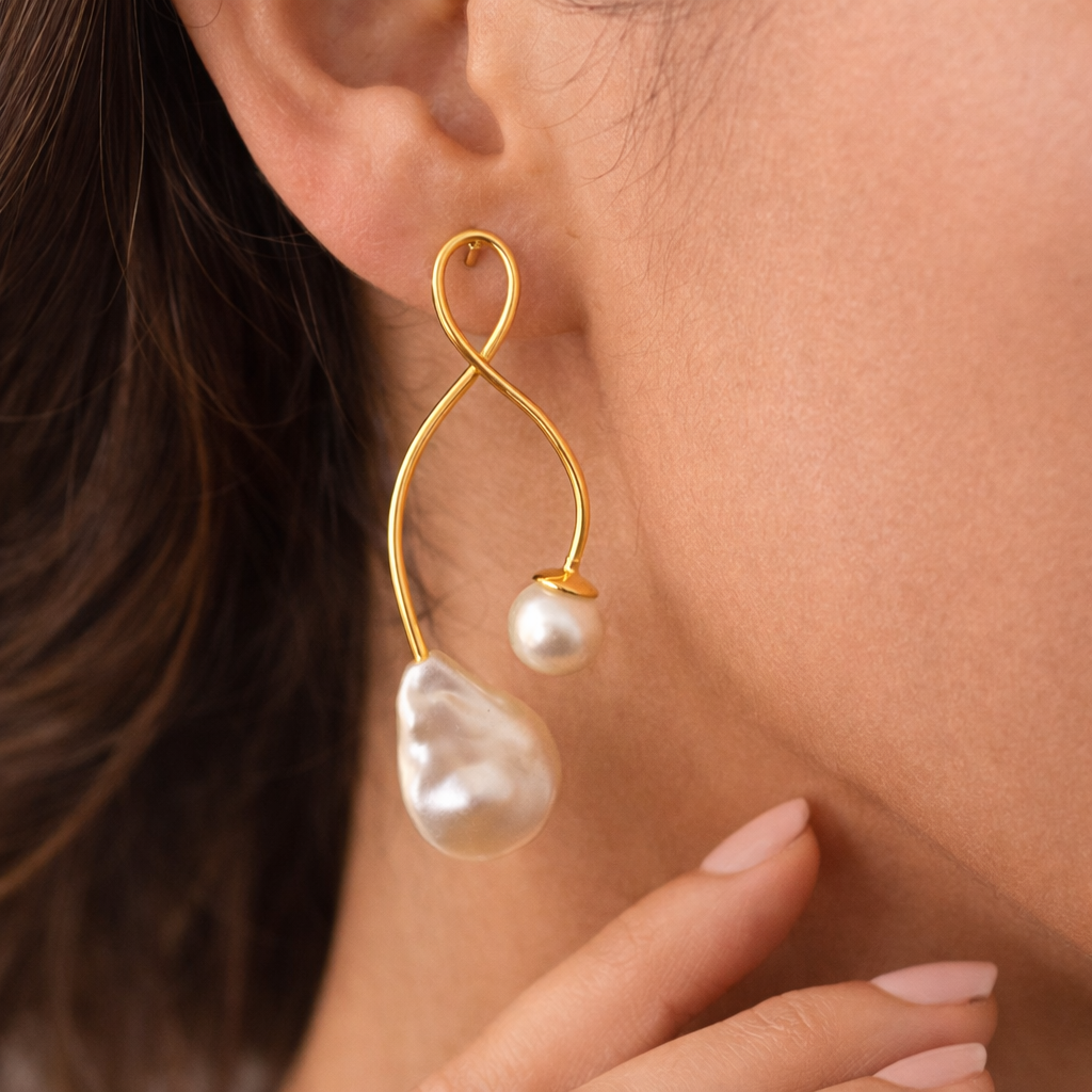 Gold earrings with pearls worn by a person