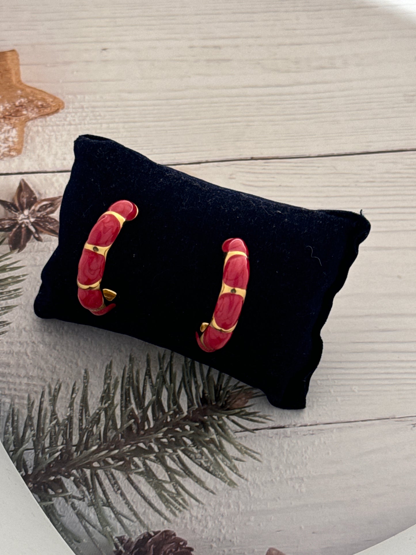 Black pouch with red and gold accents on a wooden surface with decorative elements.