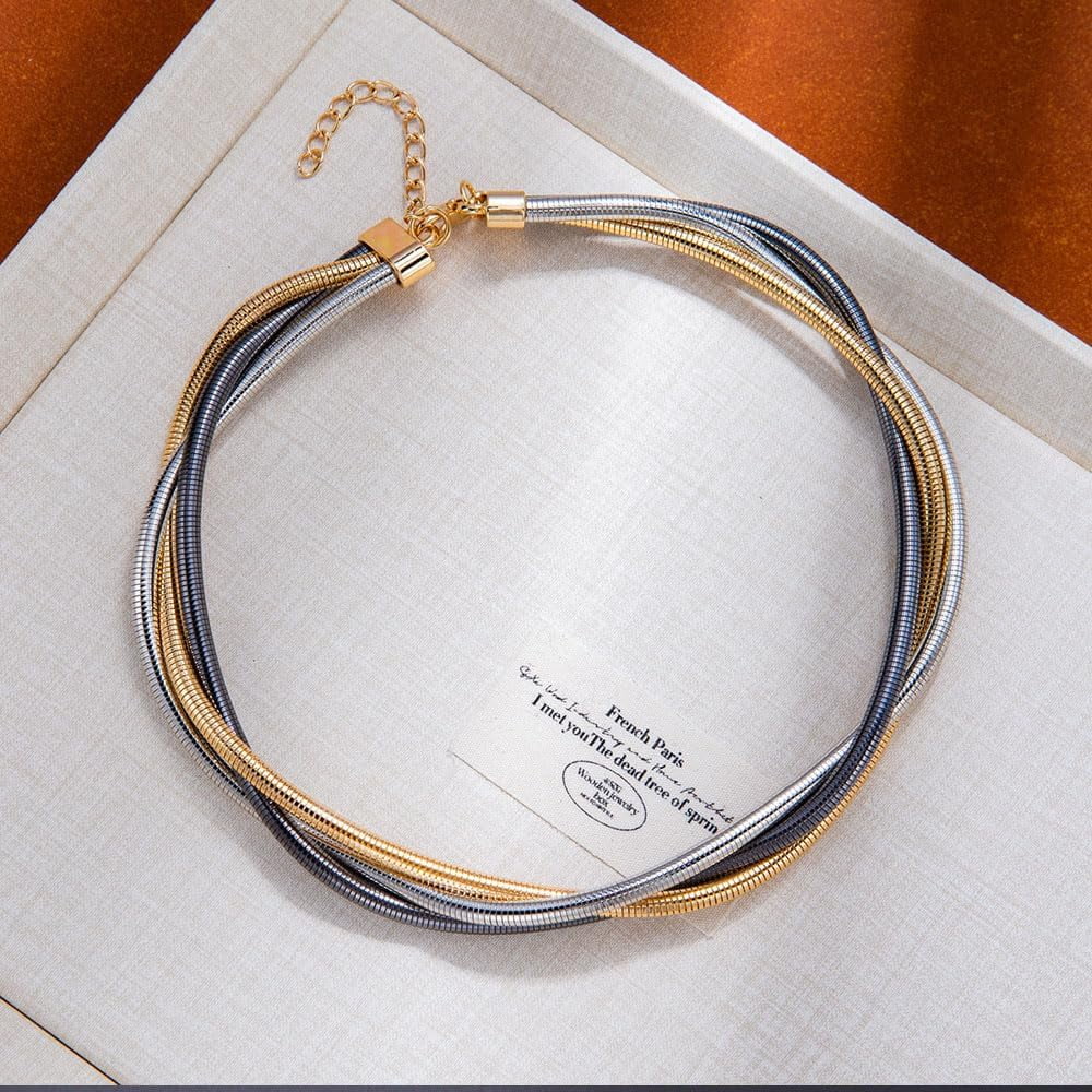 Necklace with gold and silver strands on a white box