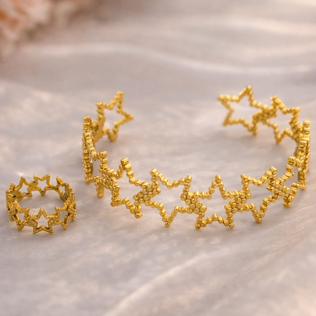 Gold star-shaped jewelry set on a soft fabric background
