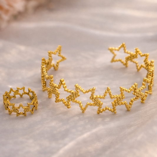 Gold star-shaped jewelry set on a soft fabric background