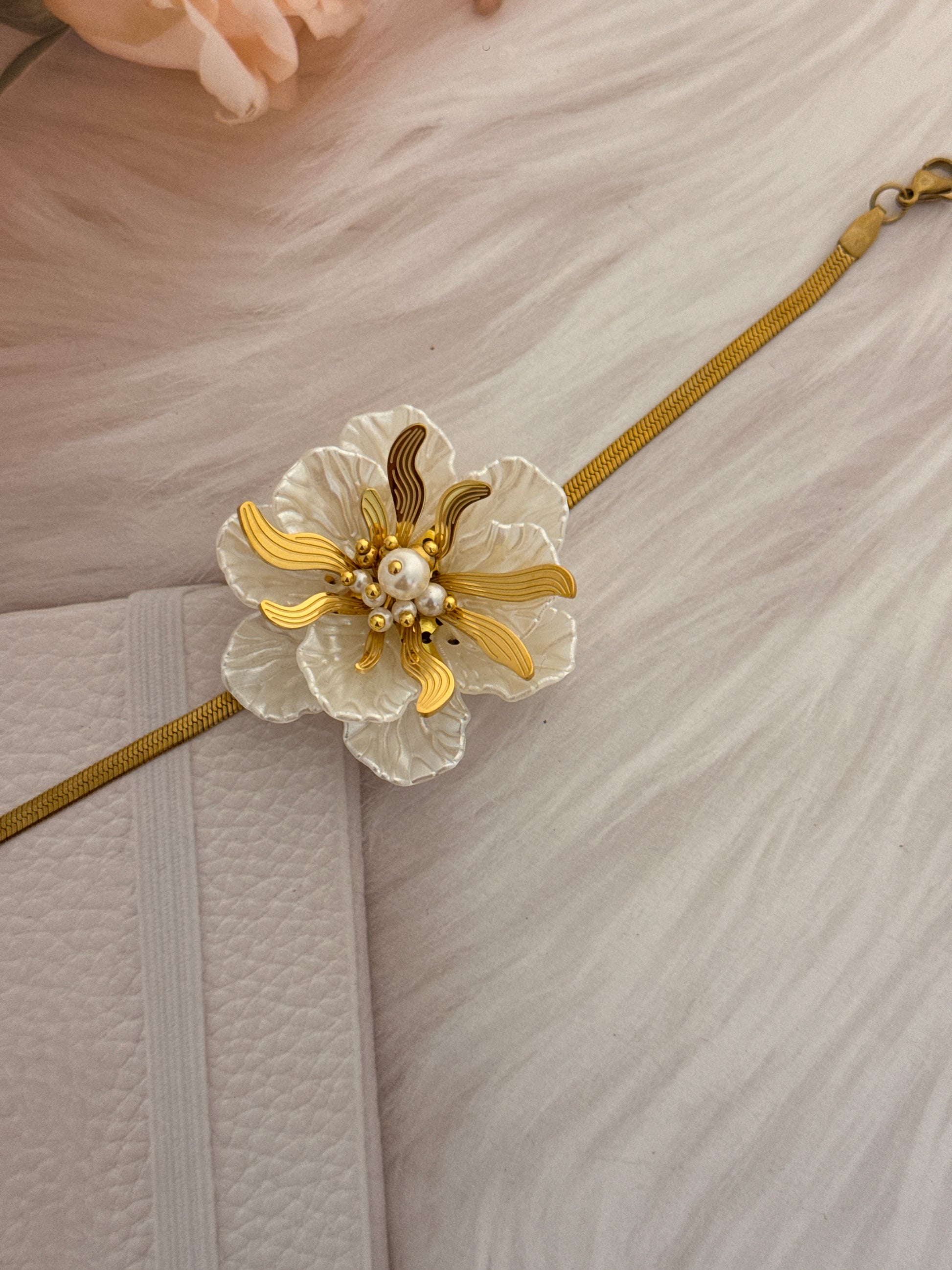 Decorative brooch with floral design on a textured surface