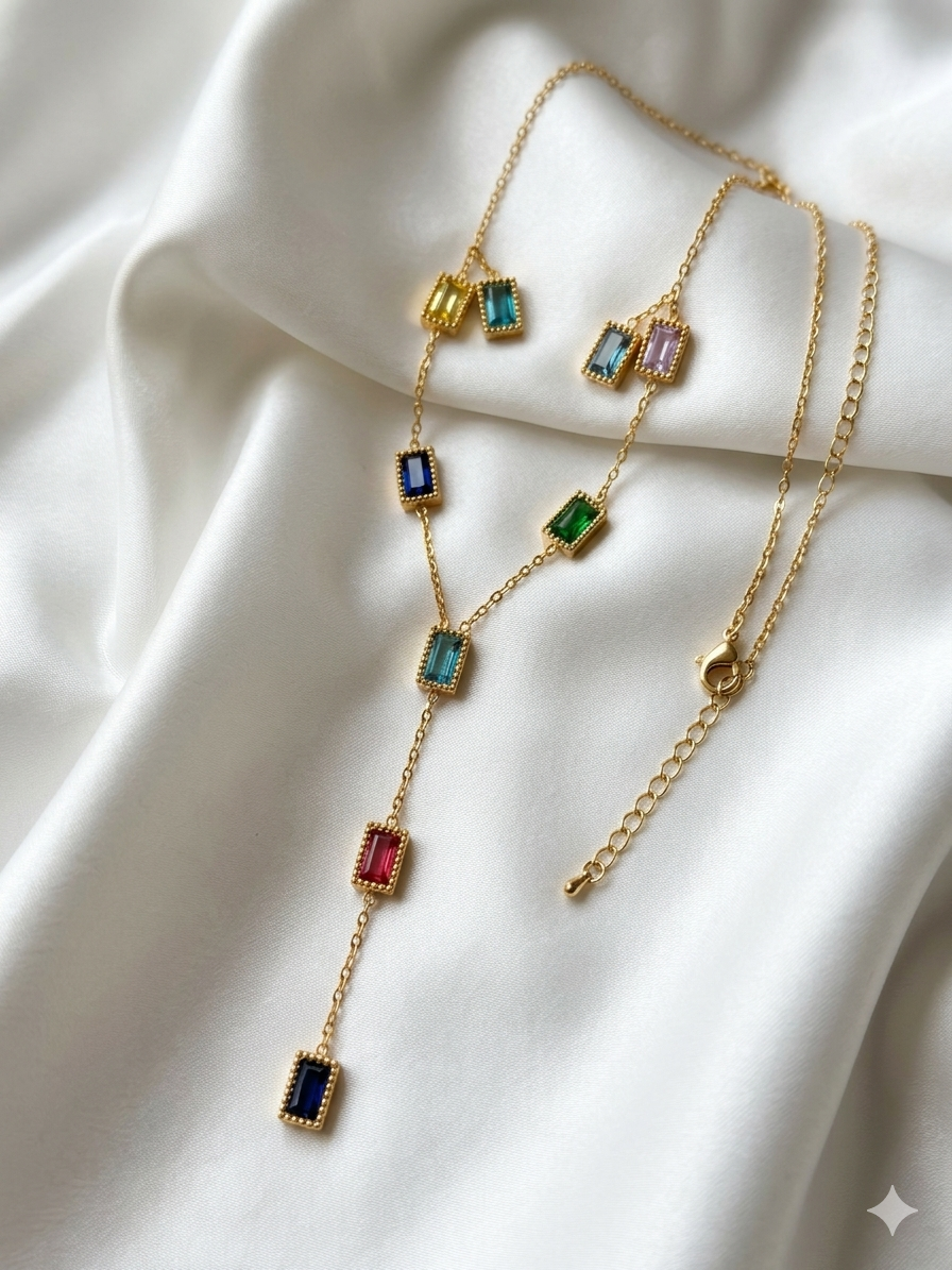 Gold necklace with colorful gemstones on a white fabric background