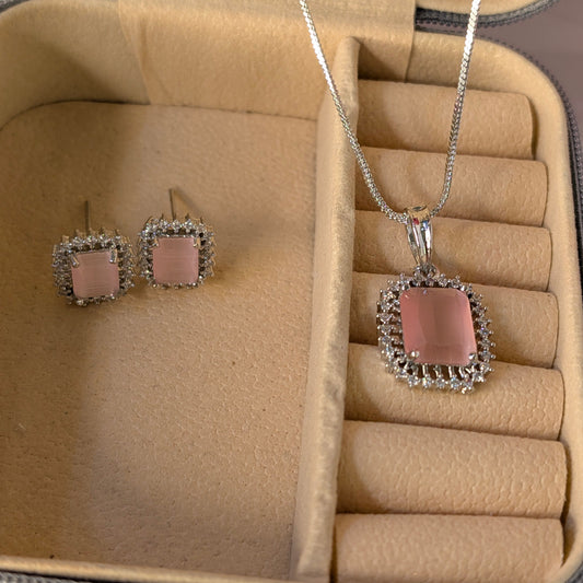 Jewelry set with pink pendant and earrings in a beige jewelry box