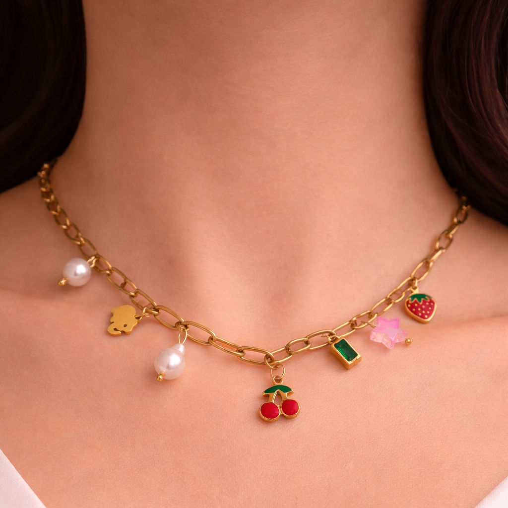 Necklace with colorful charms on a person wearing a white top